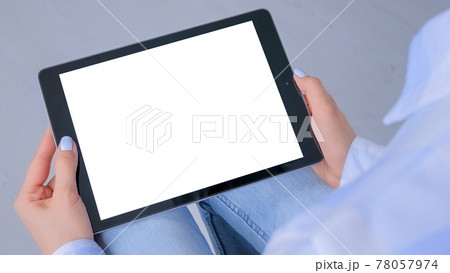 Mockup image - woman looking at tablet computer with white empty display Mockup image - woman looking at tablet computer with white empty display 78057974