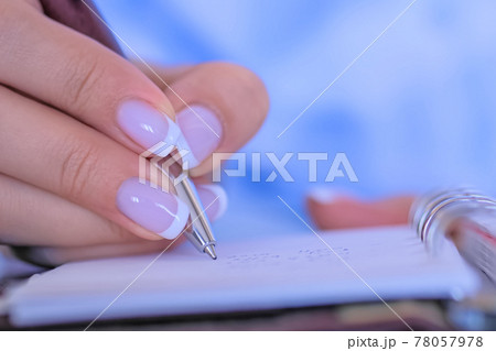 Close up top view - woman writing to do list in vintage notebook organizer Close up top view - woman writing to do list in vintage notebook organizer 78057978
