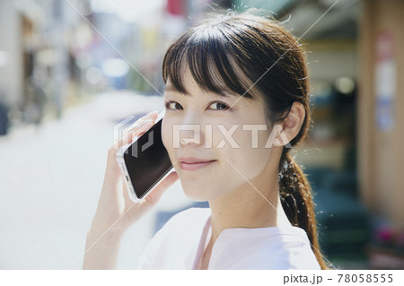 Woman with cell phone, city. Woman with cell phone, city. 78058555