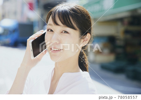 Woman with cell phone, city. Woman with cell phone, city. 78058557
