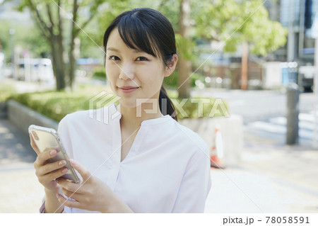 Woman with cell phone, city. Woman with cell phone, city. 78058591