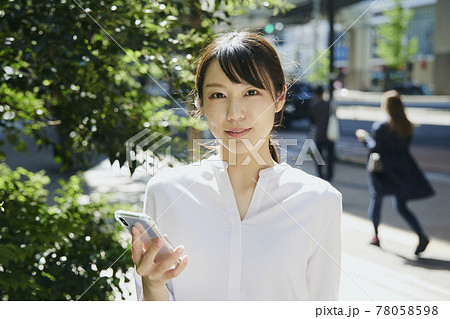 Woman with cell phone, city. Woman with cell phone, city. 78058598