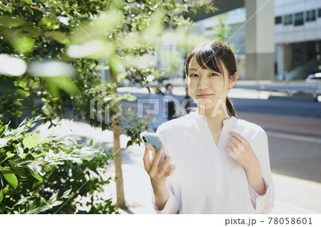 Woman with cell phone, city. Woman with cell phone, city. 78058601