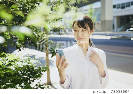 Woman with cell phone, city. Woman with cell phone, city. 78058604