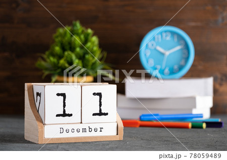 December 11th. December 11 wooden cube calendar with blur objects on background. 78059489