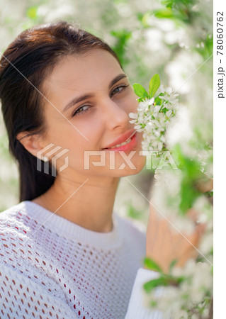 portrait.beautiful young woman by flowering tree.natural cosmetics and perfumes. 78060762