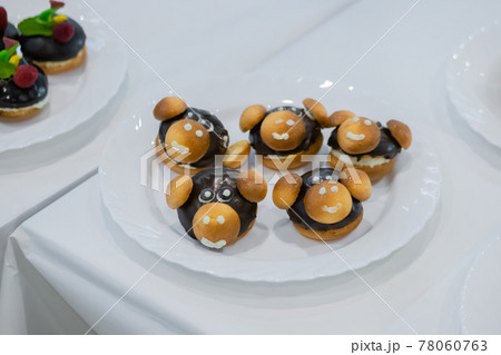 Fresh shortcrust tart cakes with chocolate and sweet mushrooms for sale 78060763