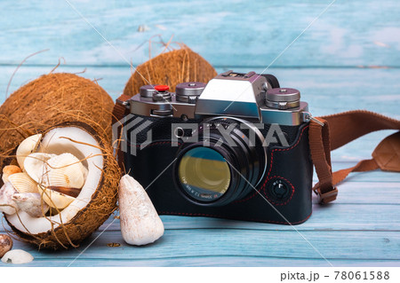 camera,coconuts and shells on a blue wooden background.Marine theme camera,coconuts and shells on a blue wooden background.Marine theme 78061588