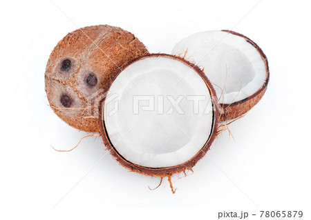 Whole and cracked coconuts isolated on white background. De-husked coconut fruits showing the characteristic three pores. Cut in half coconut closeup. 78065879