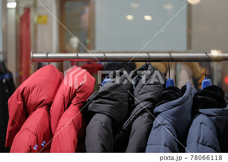 Hanger with fashionable down jackets on the shop window. 78066118