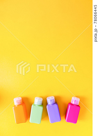 Colorful plastic bottles for skincare products or different purposes on yellow background Colorful plastic bottles for skincare products or different purposes on yellow background 78066445