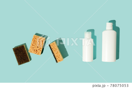 Set of neutral beige clean sponges, bottles with liquid soap or disinfect on blue background. Banner for site, concept for laundry, cleaning service, advertising, spring regular cleaning day Set of neutral beige clean sponges, bottles with liquid soap or disinfect on blue background. Banner for site, concept for laundry, cleaning service, advertising, spring regular cleaning day 78075053