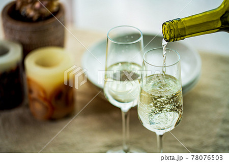 Two glasses of sparkling wine on dining table. Two glasses of sparkling wine on dining table. 78076503