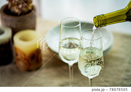 Two glasses of sparkling wine on dining table. Two glasses of sparkling wine on dining table. 78076505