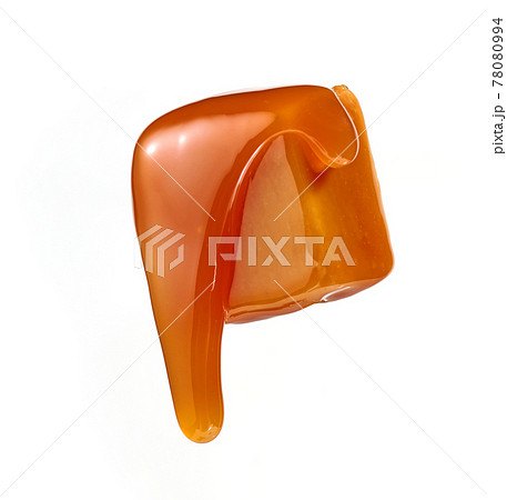 caramel sauce flowing on flying caramel candy 78080994