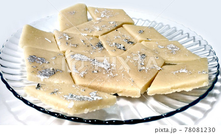 Kaju Katli is a Diamond shape Indian sweet made using cashew sugar and mava, served in a plate isolated on white background. selective focus Kaju Katli is a Diamond shape Indian sweet made using cashew sugar and mava, served in a plate isolated on white background. selective focus 78081230
