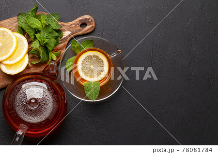 Herbal tea with mint and lemon. Tea cup and teapot Herbal tea with mint and lemon. Tea cup and teapot 78081784