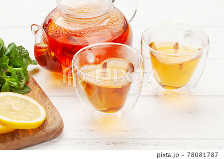 Herbal tea with mint and lemon. Tea cup and teapot 78081787
