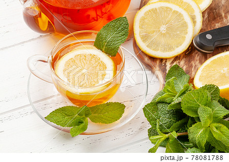 Herbal tea with mint and lemon. Tea cup and teapot 78081788