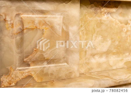 Carved patterns on stone luxury fireplace close up Carved patterns on stone luxury fireplace close up 78082456