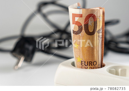 A fifty euro banknote is plugged into a power strip. Close-up. Extension socket. Macro. Electro efficiency and energy saving concept 78082735