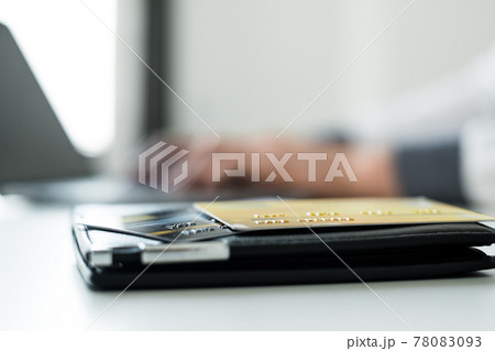 The businessman's hand is holding a credit card and using a laptop for online shopping and internet payment 78083093