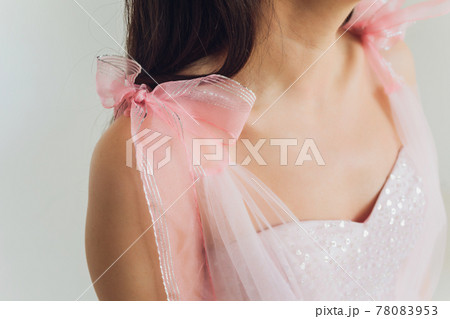 Charming bridesmaid dress with a delicate bow, rhinestones, embroidery and shiny beads close-up. 78083953