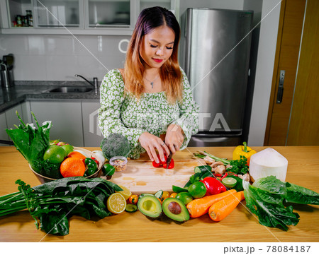 Asian girl cooking healthy vegetarian and vegan food, vegetables and fruits in the kitchen, healthy 78084187