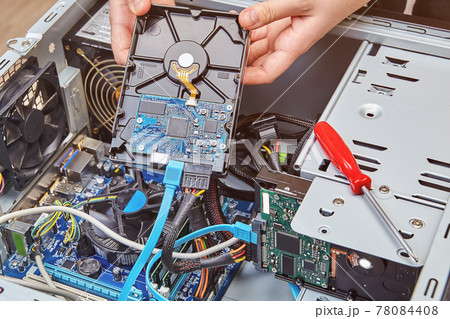 Removing computer hard drive from system unit to replace it with new one. 78084408