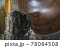 Large industrial cutting machine cuts gray granite stone into slabs 78084508
