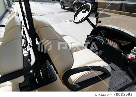 Electric golf car parked near hotel building 78085992