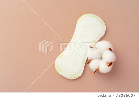 Women medical pads and cotton flower on paper background 78086007