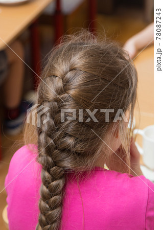 Close-up of a girl's hairstyle with a lush braid, view from the back Close-up of a girl's hairstyle with a lush braid, view from the back 78087243