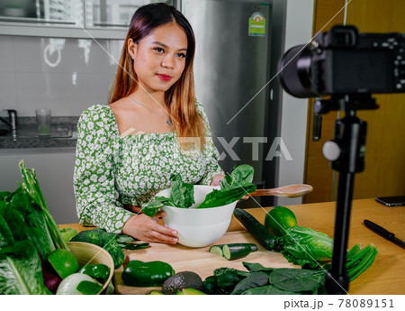 Asian woman blogger or content creator cooking and recording video camera. showing healthy food 78089151