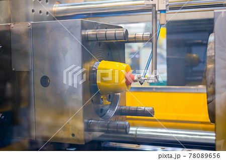 Injection molding machine during work: production of empty plastic cup: close up Injection molding machine during work: production of empty plastic cup: close up 78089656