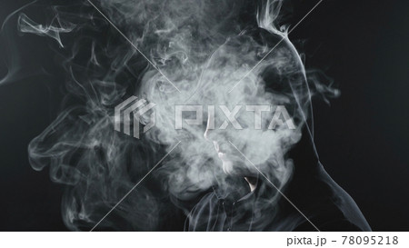 Man in black hood with the smoke inside 78095218
