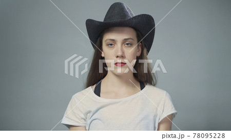 Photo of young woman in cowboy hat on grey 78095228
