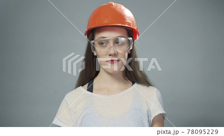 Photo of woman with orange helmet and glasses 78095229
