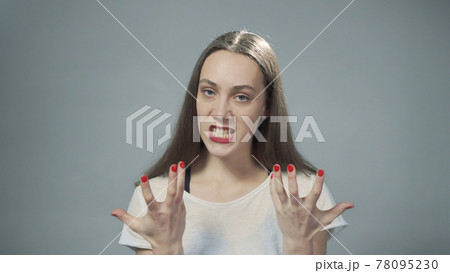 Photo of young angry girl on grey 78095230