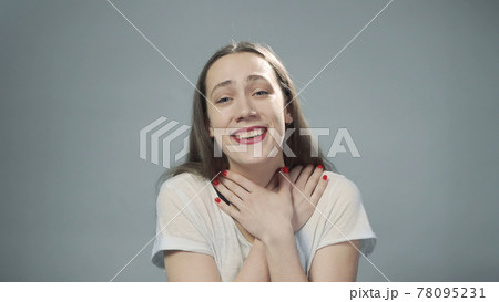 Photo of young happy girl on grey 78095231