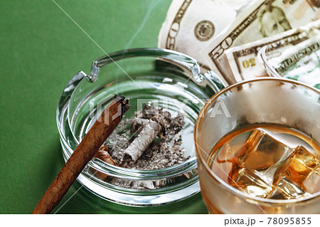 Cuban cigar and money on green background Cuban cigar and money on green background 78095855