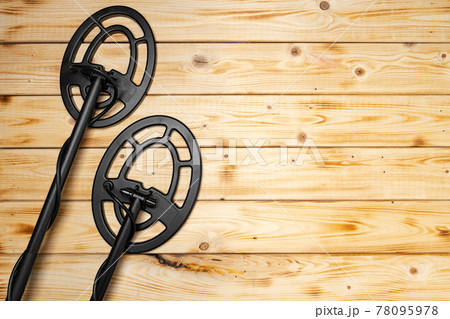 Metal detector on wooden background top view Metal detector on wooden background top view 78095978