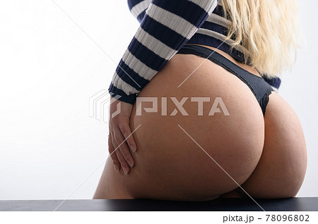 Rear view of a girl in thongs and a striped sweater 78096802