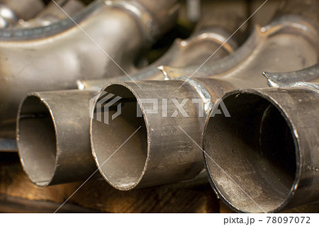 Metal pipes for the automotive industry are stored in a warehouse on a rack.	 78097072