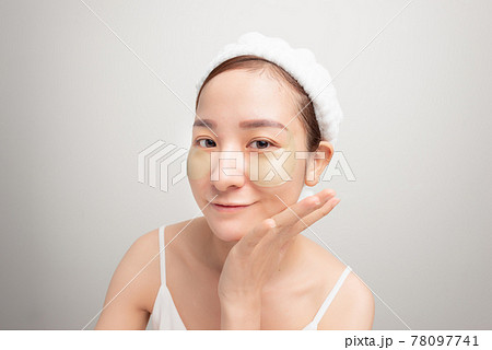 woman with an eye patches touching temples. woman with an eye patches touching temples. 78097741