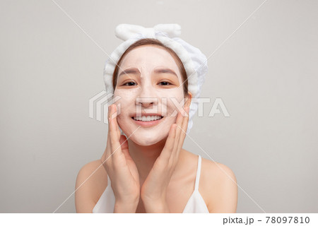 emotional funny girl is looking at the mirror. close up photo. studio shot. grey background 78097810