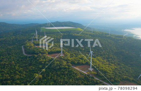 Aerial top view of wind turbines or windmills farm field with water in lake or river in industry factory. Power, sustainable green clean energy, and environment concept. Nature innovation. Aerial top view of wind turbines or windmills farm field with water in lake or river in industry factory. Power, sustainable green clean energy, and environment concept. Nature innovation. 78098294