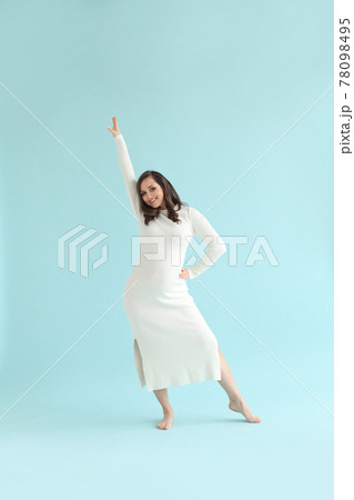 Happy pregnant woman dancing on blue background 78098495