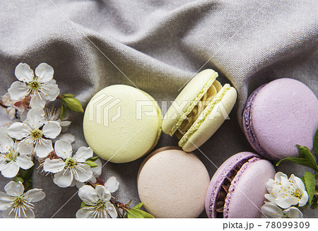 French sweet macaroons colorful variety on a gray textile background French sweet macaroons colorful variety on a gray textile background 78099309