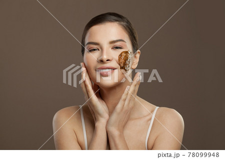 Smiling spa woman with scrub on her skin Smiling spa woman with scrub on her skin 78099948